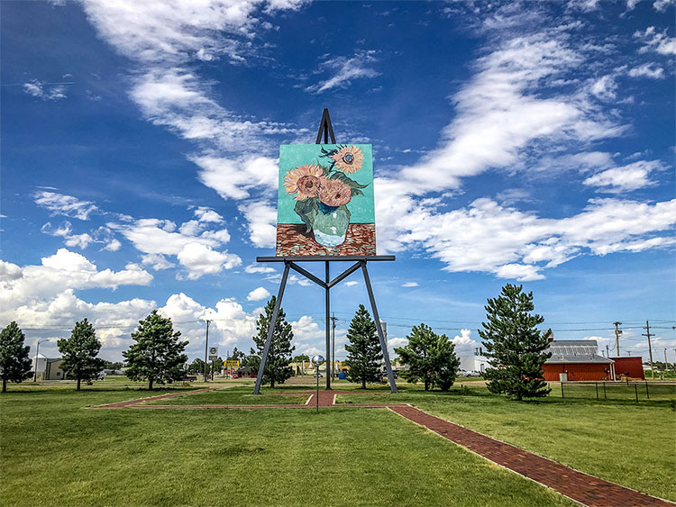 Worlds Largest Easel on a summer day with clouds