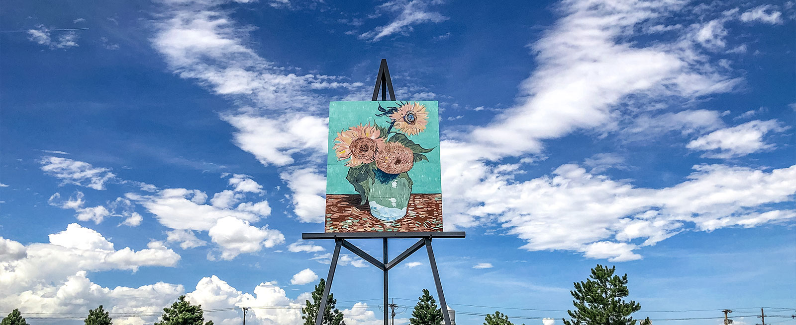 Worlds Largest Easel on a summer day with clouds