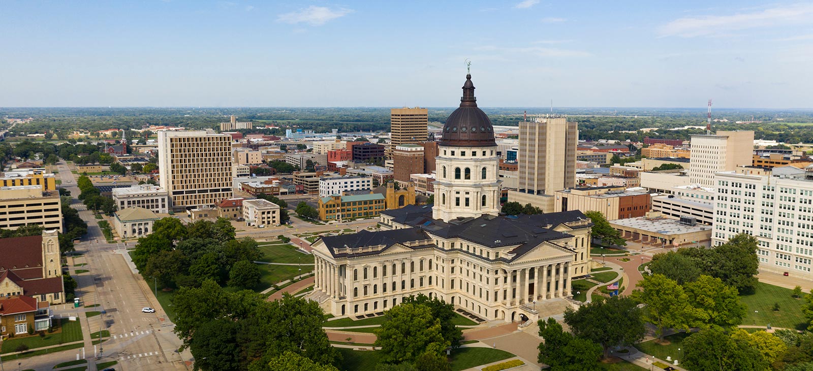 Kansas State Capitol building exterior in Topeka with clear blue sky in the background